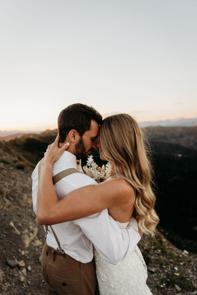 Couple posing in the mountains during elopement photoshoot