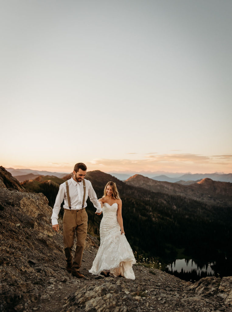 Couple hiking up mountain during adventure elopement