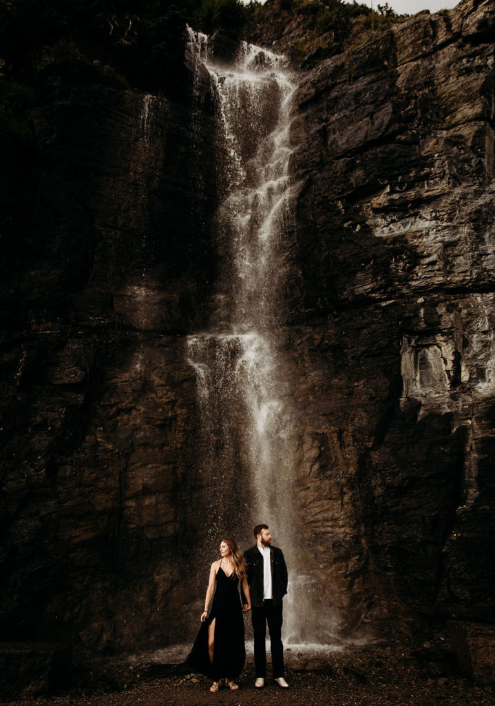 couple posing in front of waterfall