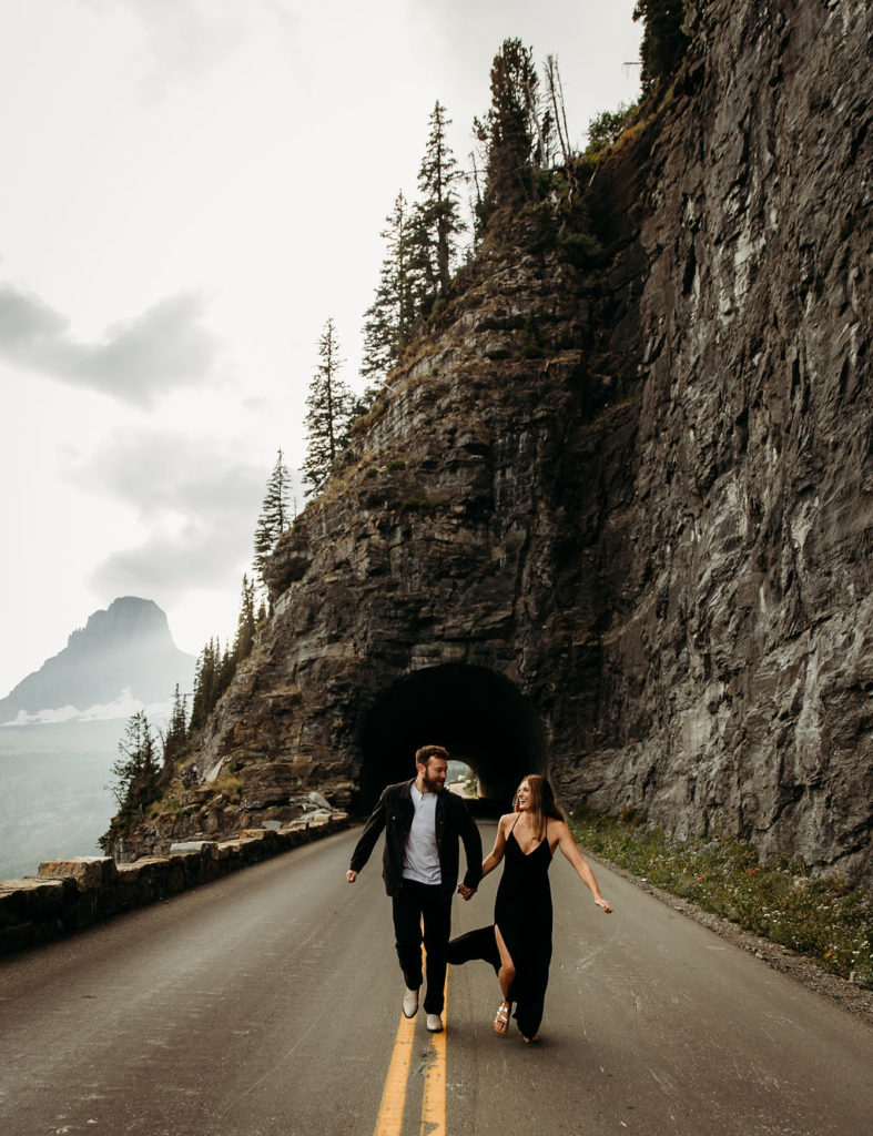 Couple posing for mountain engagement photos in Glacier National Park