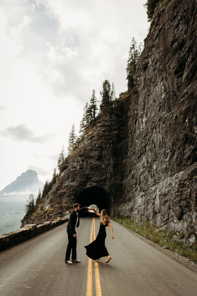 Couple posing for mountain engagement photos in Glacier National Park