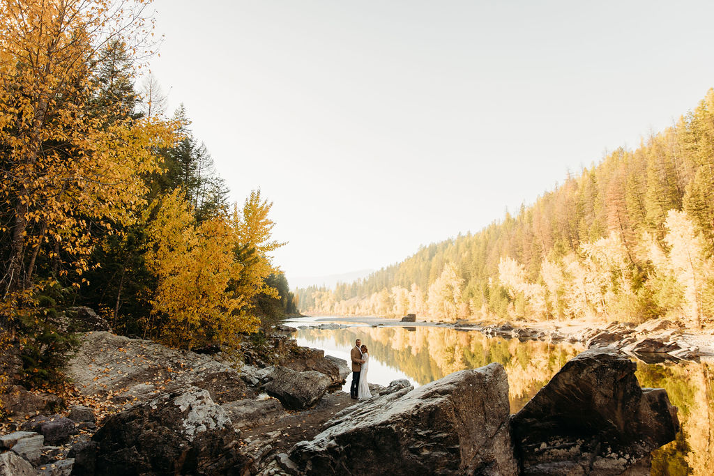 Bride and groom posing for fall elopement wedding portraits in Glacier National Park