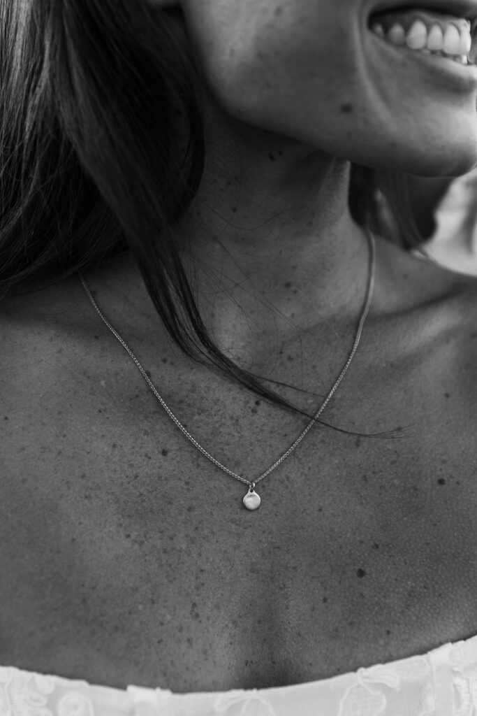 Woman with freckles wearing necklace