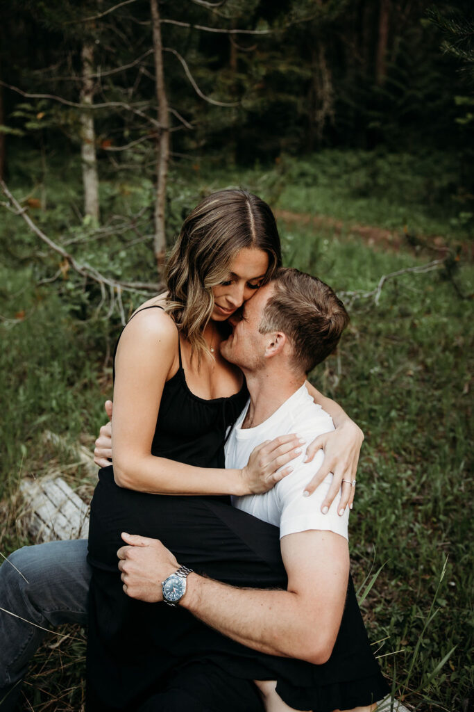 Couple posing for Glacier National Park engagement photos captured by Photography by Brogan - Montana Photographer