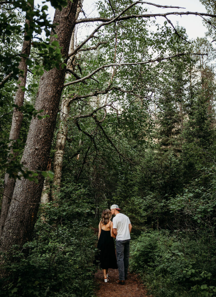 Couple posing for photos in the Montana forest