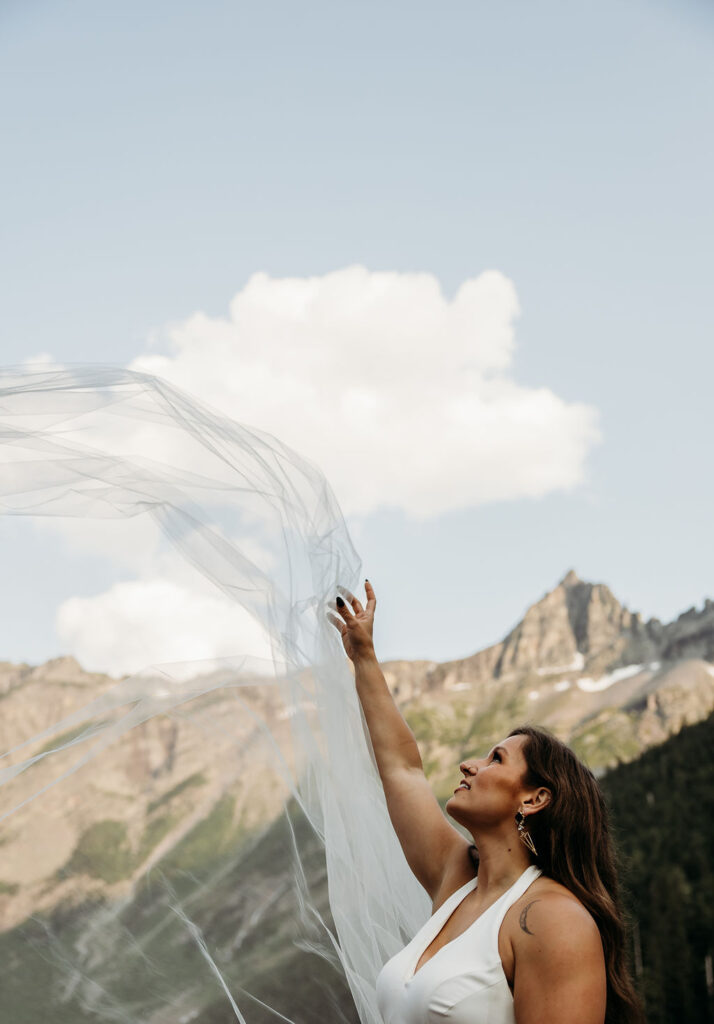 Bride throwing veil into the air