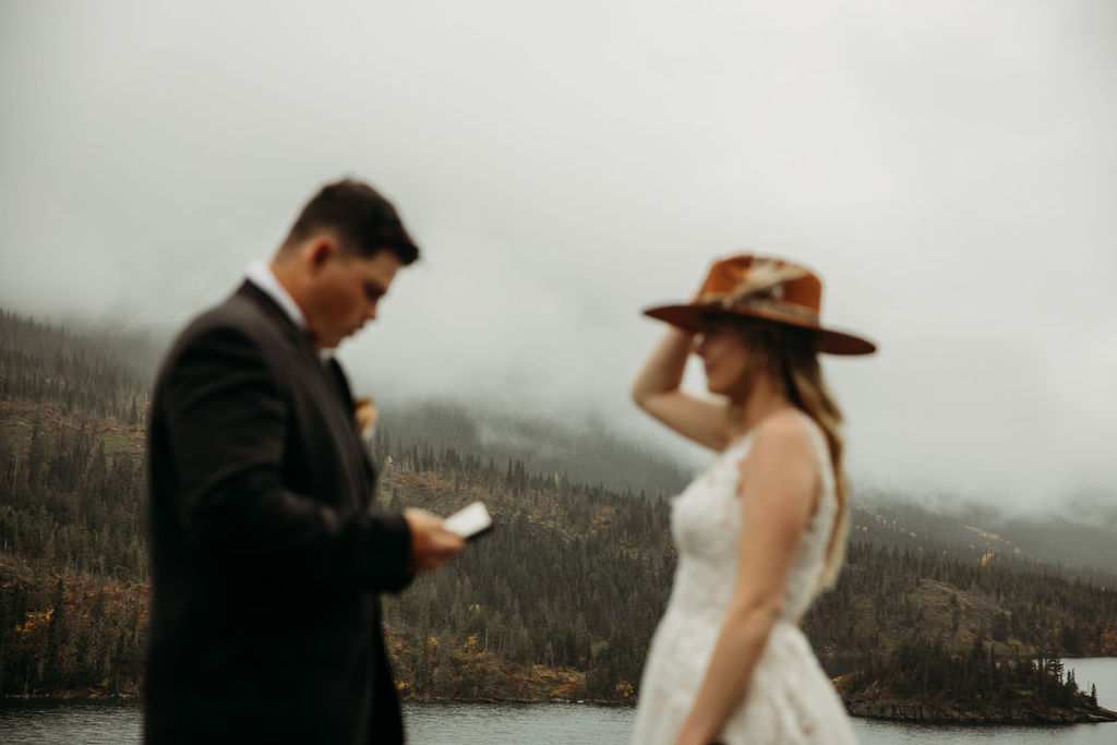 Bride and groom exchanging private vows in the mountains 