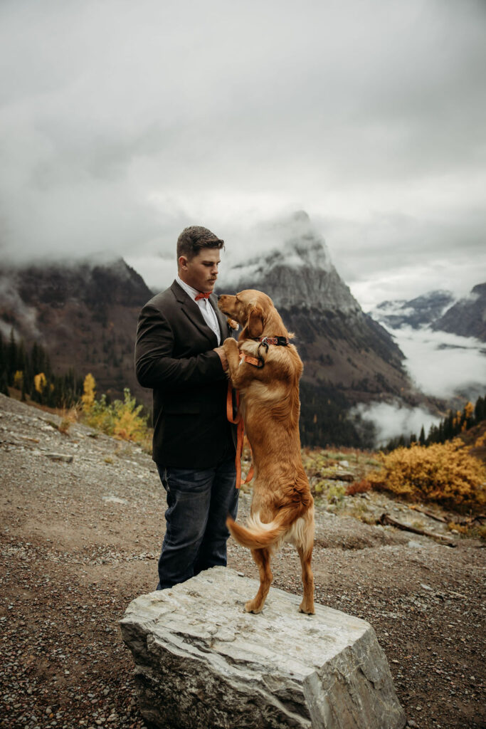 Groom with his dog in the mountains