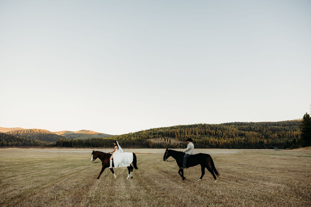 Bride and groom riding horses for their portraits from their western fall wedding in Montana at Star Meadows Ranch