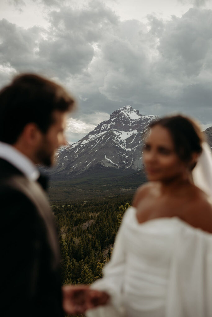 a couple posing in glacier national park for their wedding
