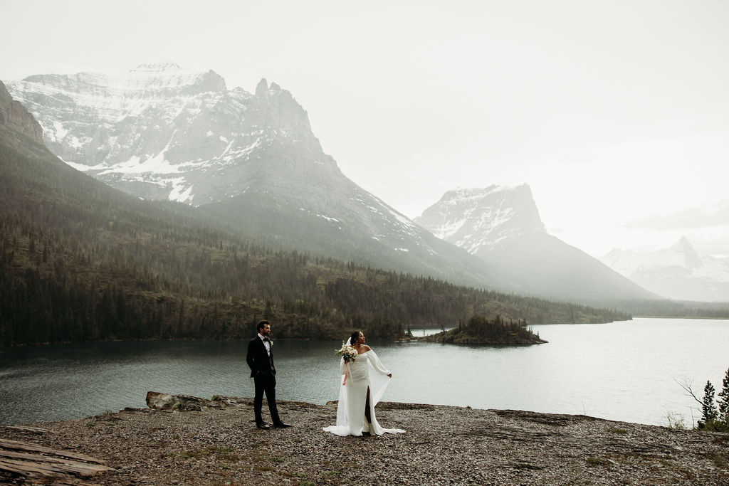a couple posing in glacier national park for their elopement