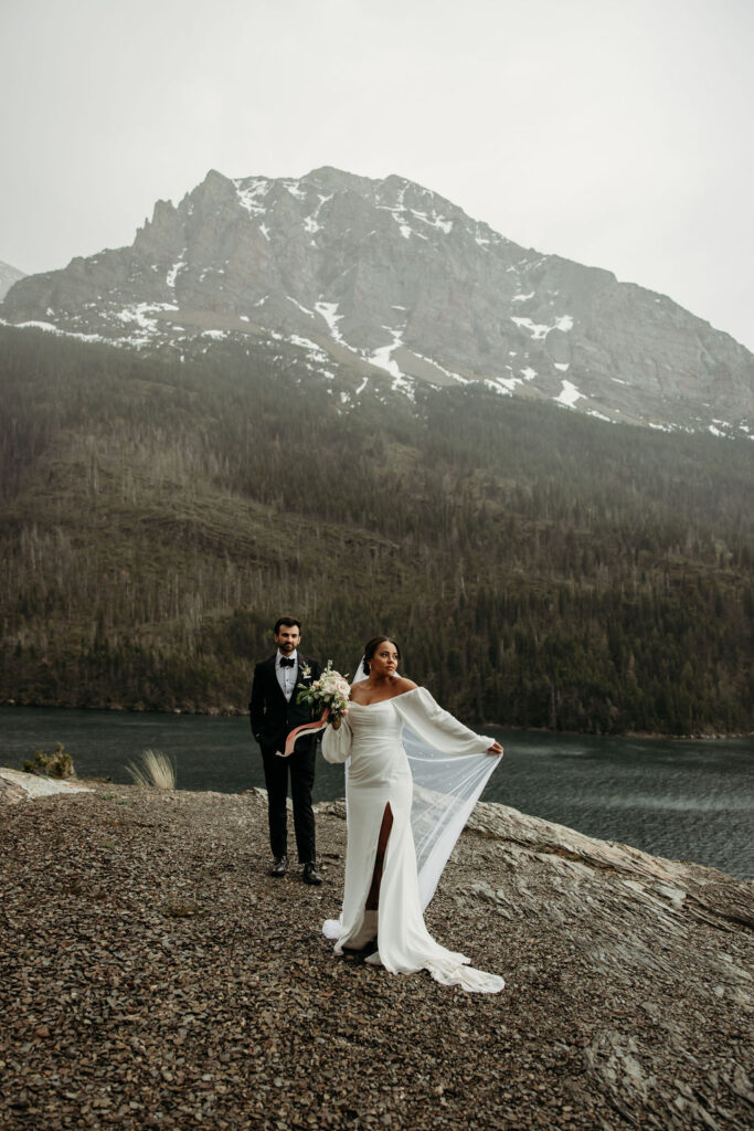 a couple posing in glacier national park for their elopement
