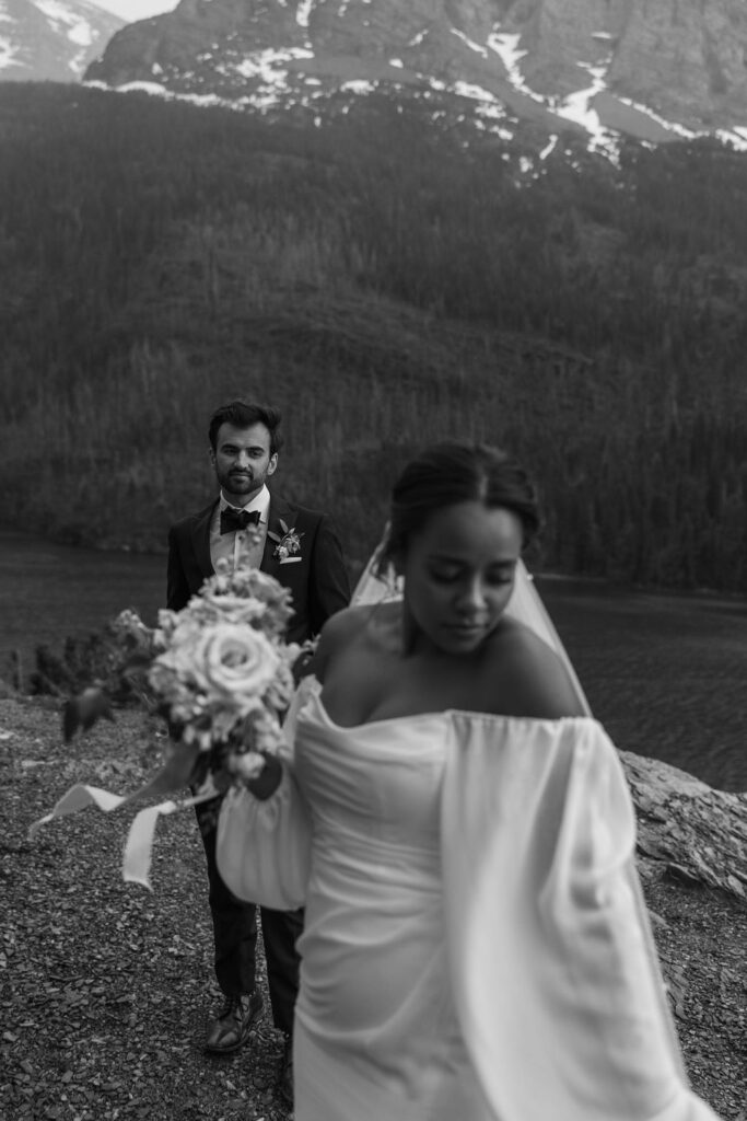 a couple posing in glacier national park for their wedding
