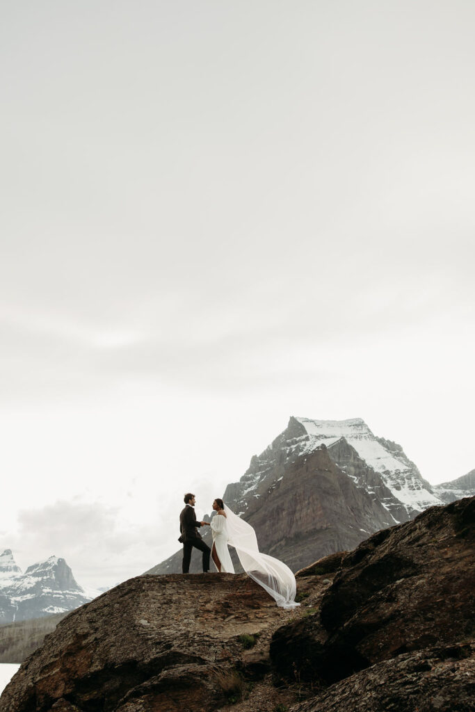 a couple posing in glacier national park for their wedding