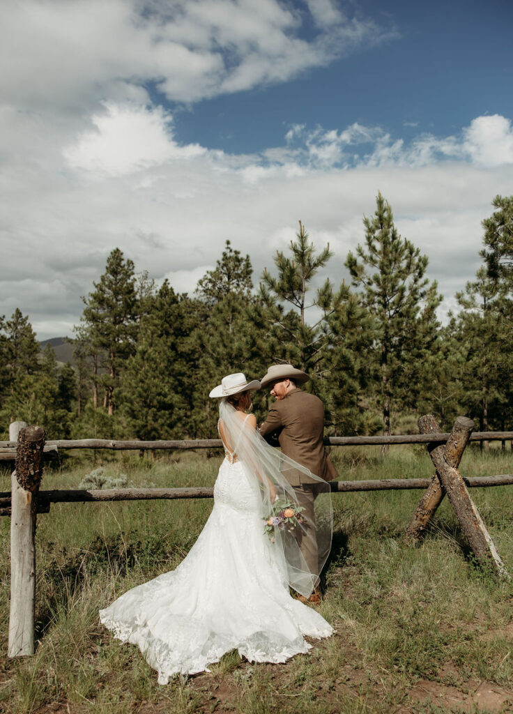 bride and groom posing for wedding portraits
