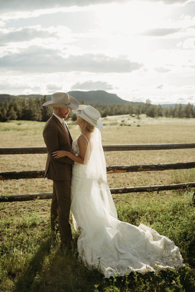 bride and groom posing for wedding portraits
