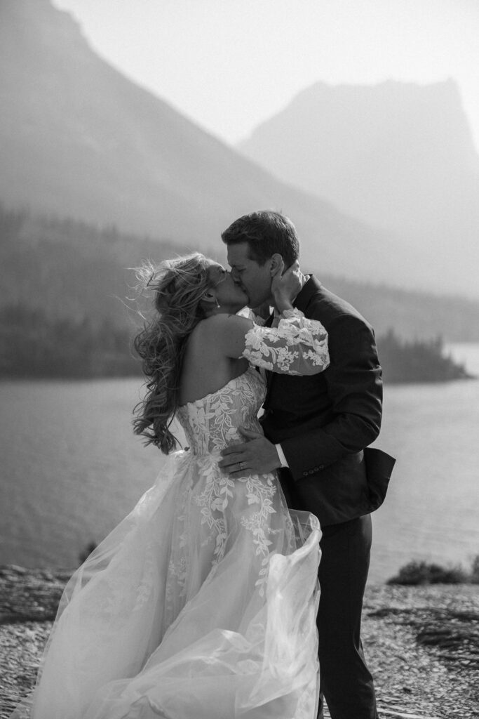 bride and groom taking elopement photos at going to the sun road
