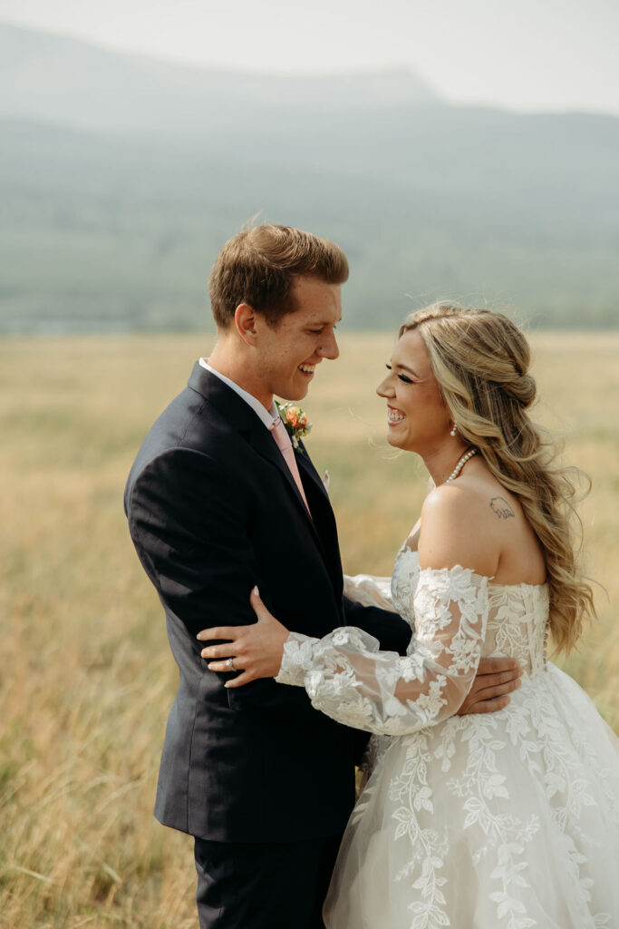 bride and groom taking elopement photos at going to the sun road
