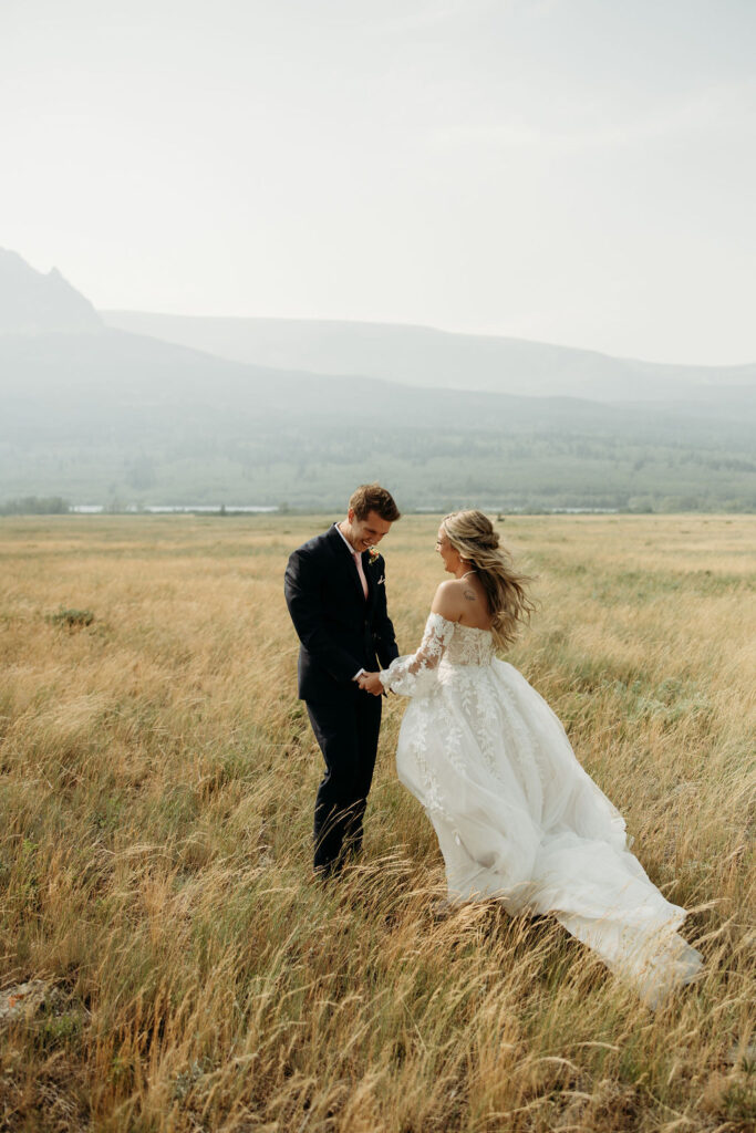 bride and groom taking elopement photos at going to the sun road
