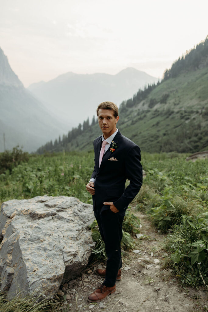 bride and groom taking elopement photos at going to the sun road
