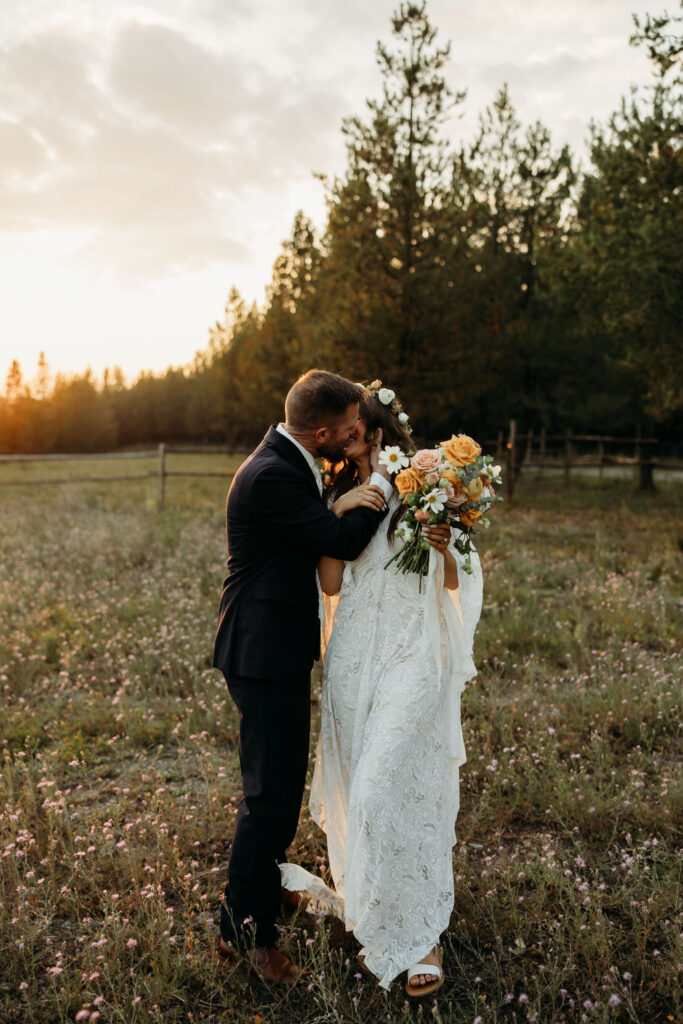 couple taking elopement photos at bowman lake