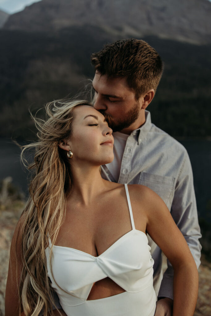 couple posing in glacier national park
