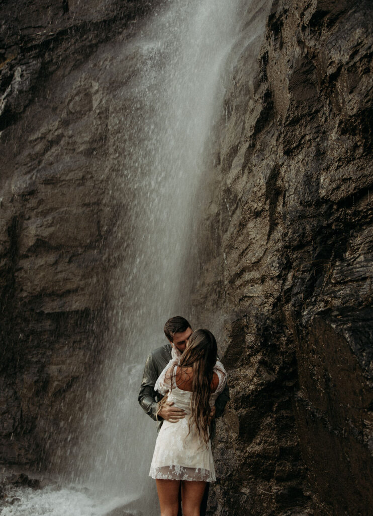 couple posing in glacier national park
