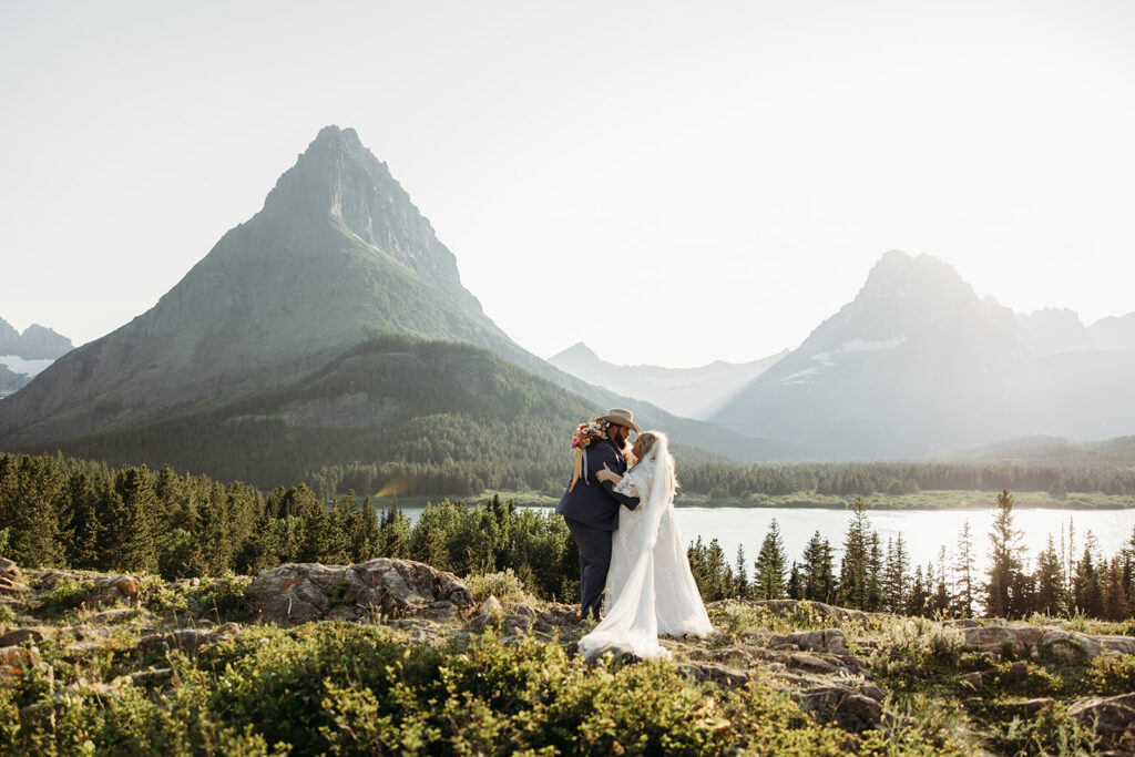 couple posing for their glacier national park elopement
