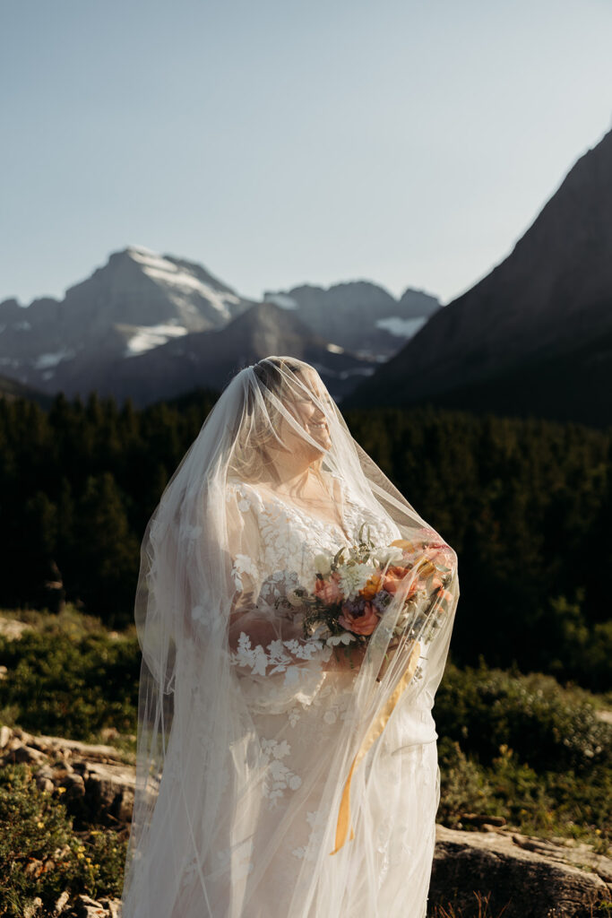 couple posing for their glacier national park elopement
