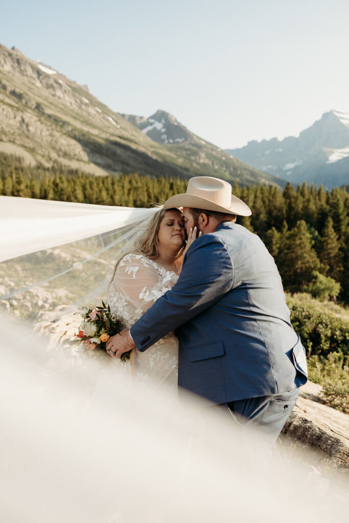 couple posing for their glacier national park elopement
