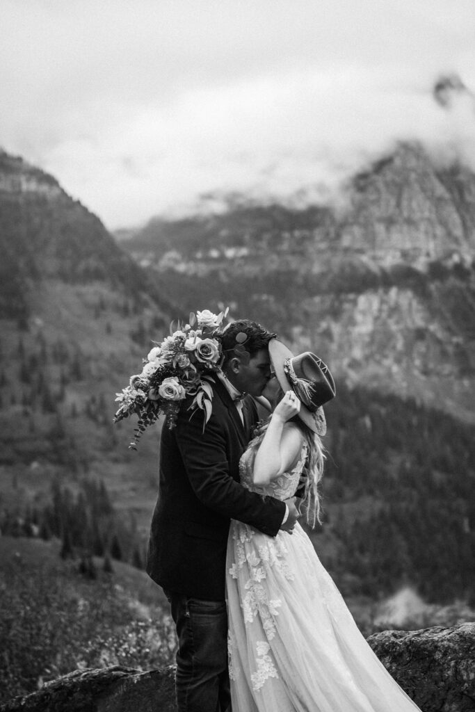 A couple standing together during their adventurous elopement photoshoot in Glacier National Park, Montana, surrounded by stunning natural scenery.
