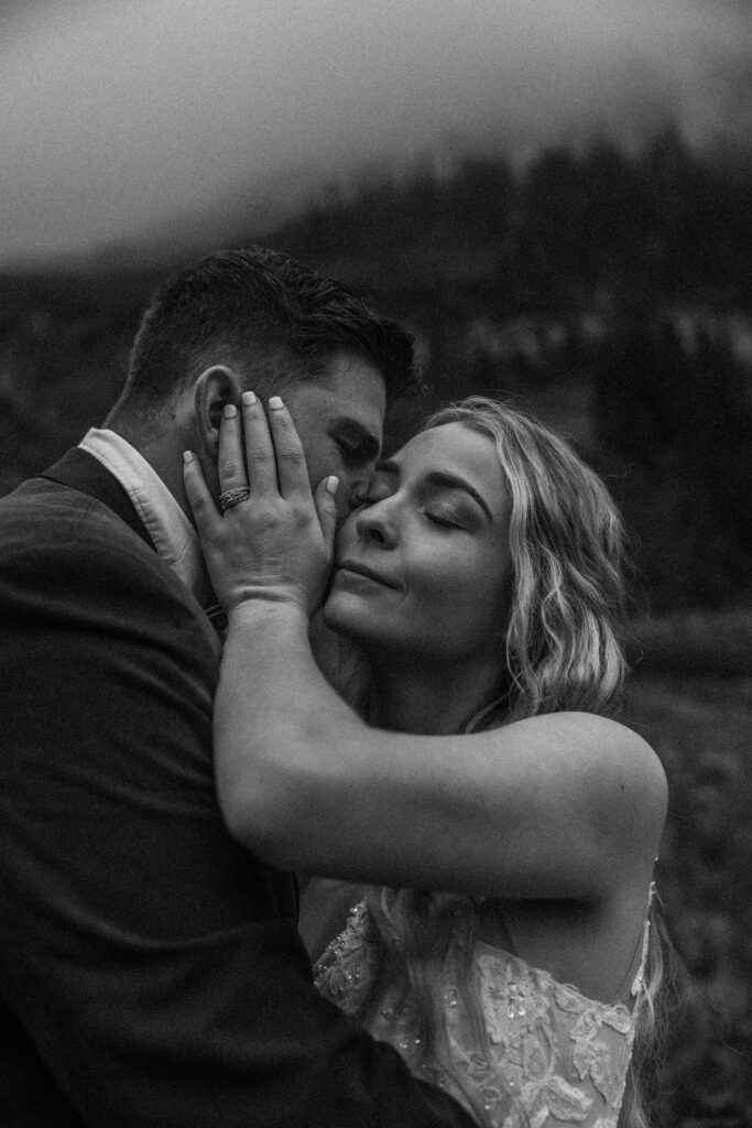 Two lovebirds embracing the adventure of their elopement, posing in the scenic surroundings of Glacier National Park, Montana.
