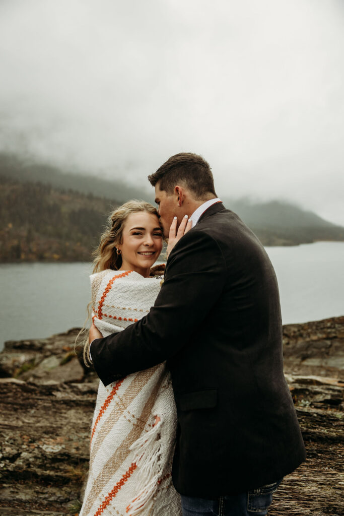 A couple capturing their elopement memories in Glacier National Park, Montana, with a backdrop of rugged beauty and wide-open spaces.
