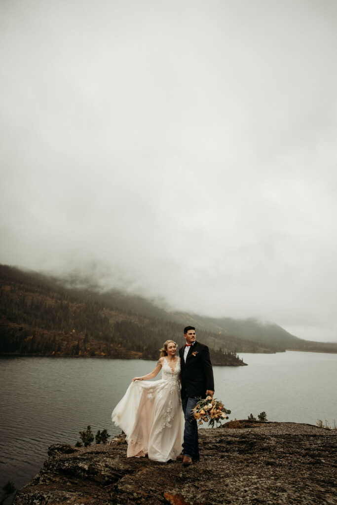 A couple capturing their elopement memories in Glacier National Park, Montana, with a backdrop of rugged beauty and wide-open spaces.
