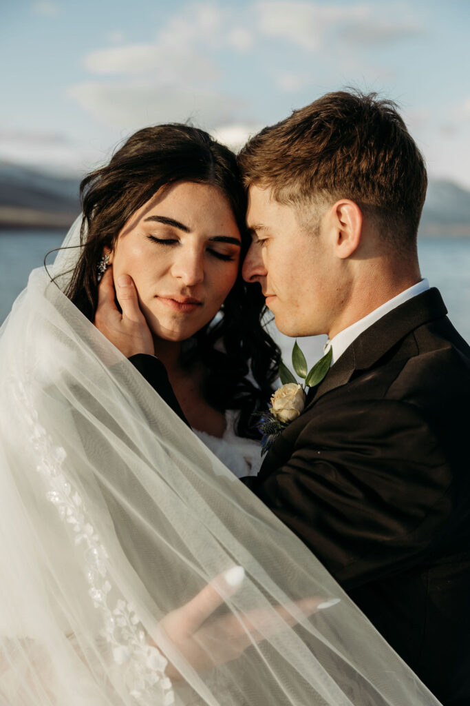 An adventurous pair posing for their elopement photos amidst the breathtaking landscapes of Glacier National Park in Montana.
