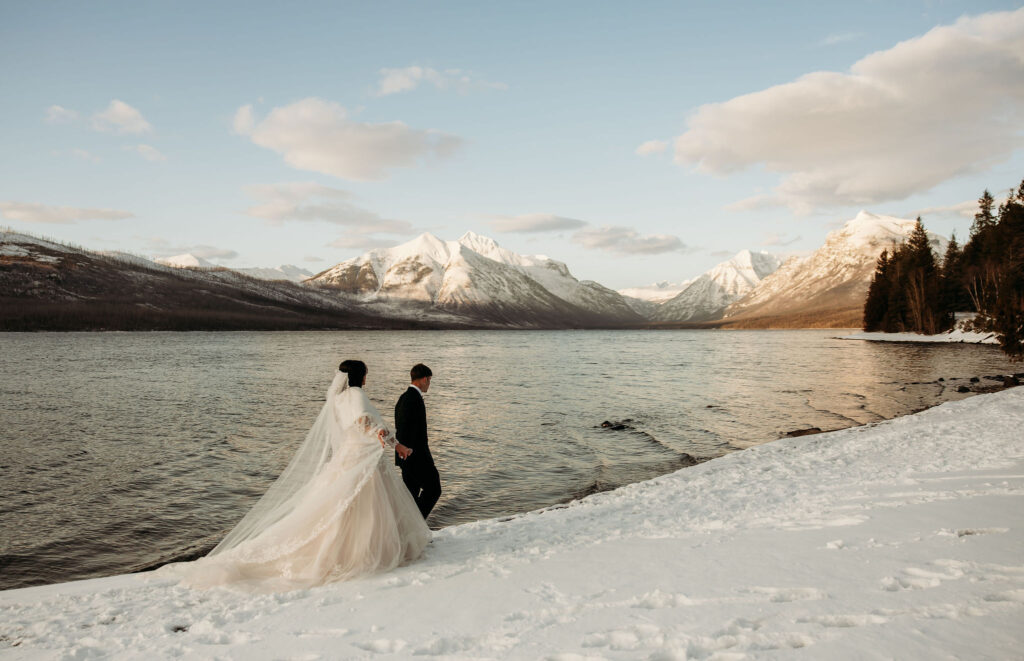 An adventurous couple posing in Glacier National Park, with breathtaking scenery all around.
