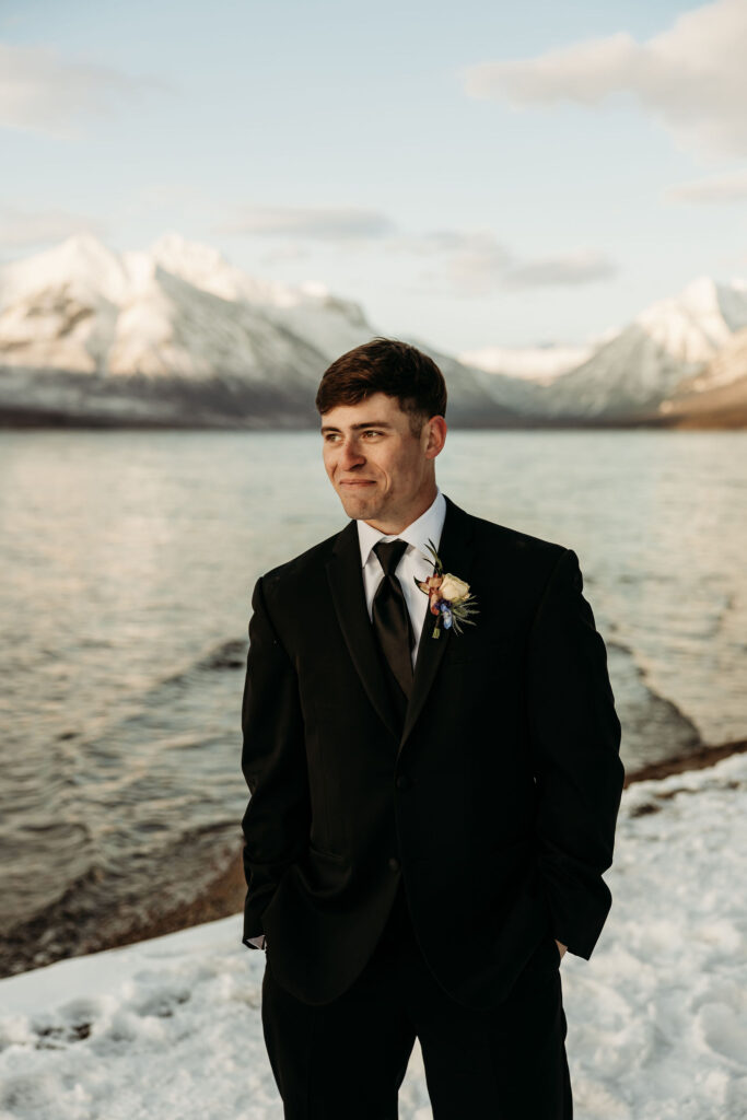 A romantic moment captured as a couple celebrates their elopement in Glacier National Park's rugged beauty.
