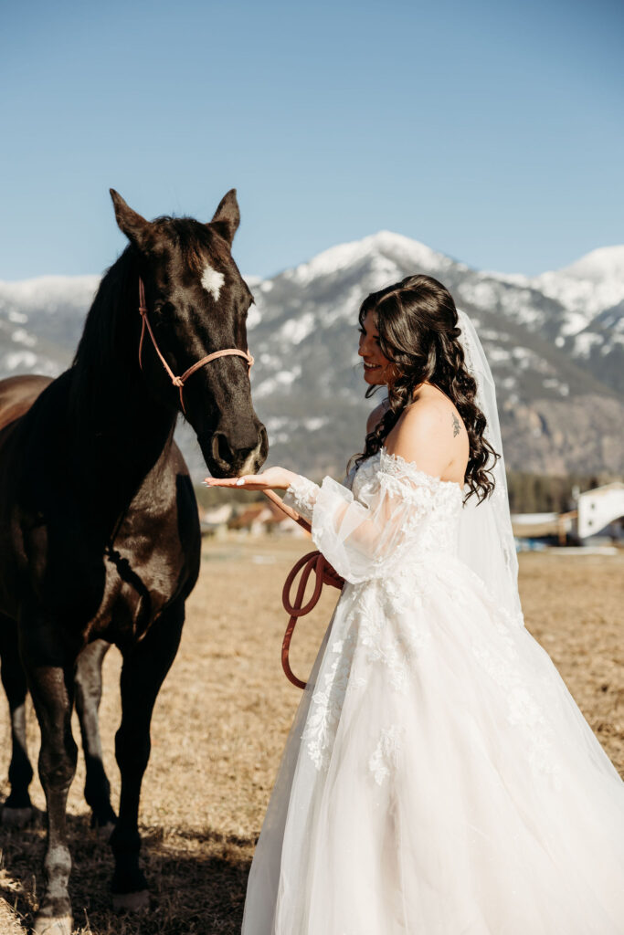 An adventurous pair posing for their elopement photos amidst the breathtaking landscapes of Glacier National Park in Montana.
