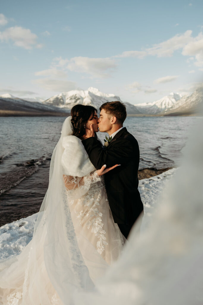 Two lovebirds embracing the adventure of their elopement, posing in the scenic surroundings of Glacier National Park, Montana.
