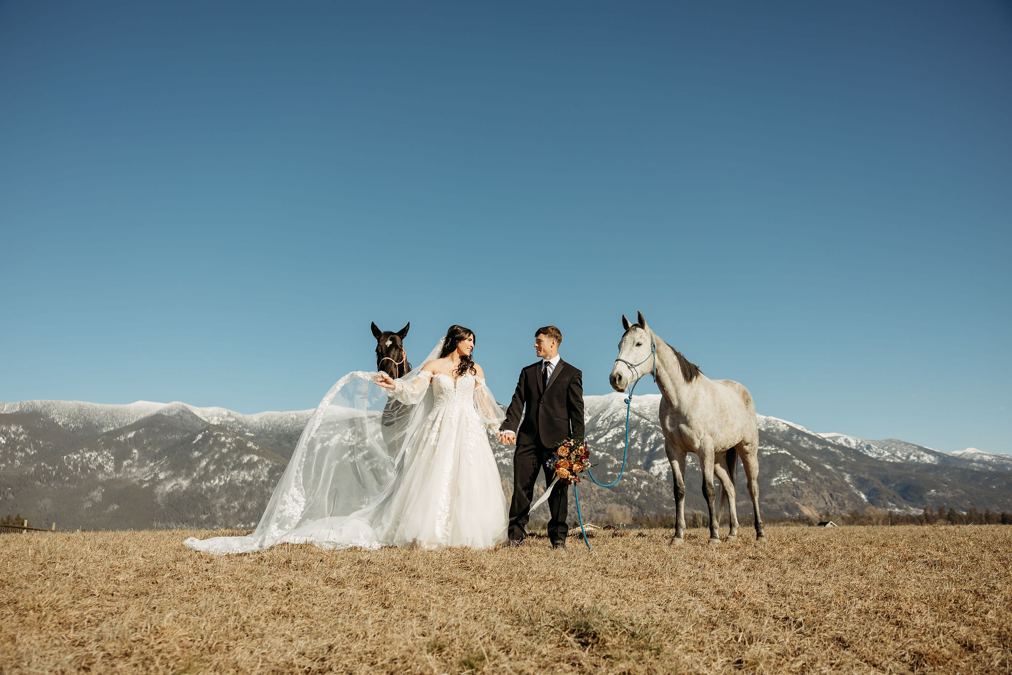 A couple standing together during their adventurous elopement photoshoot in Glacier National Park, Montana, surrounded by stunning natural scenery.