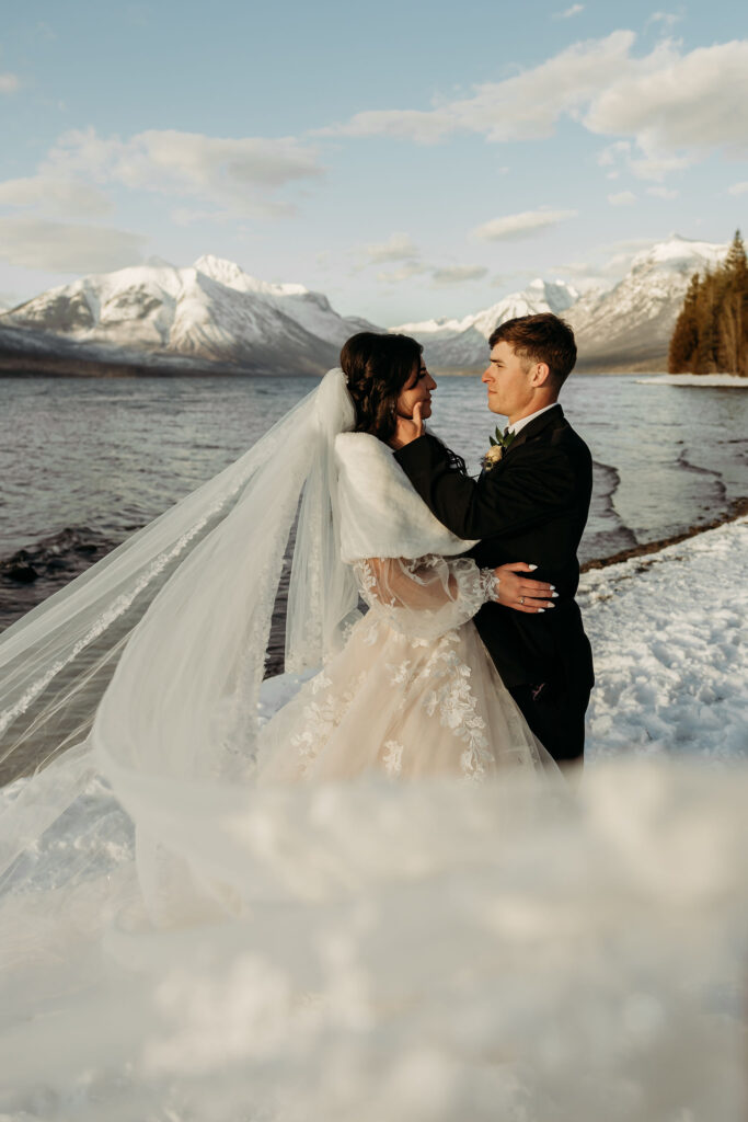 An adventurous pair posing for their elopement photos amidst the breathtaking landscapes of Glacier National Park in Montana.
