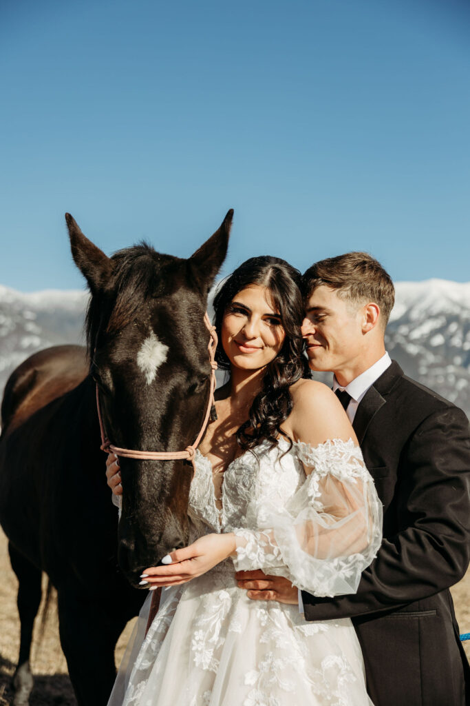 Two lovebirds embracing the adventure of their elopement, posing in the scenic surroundings of Glacier National Park, Montana.