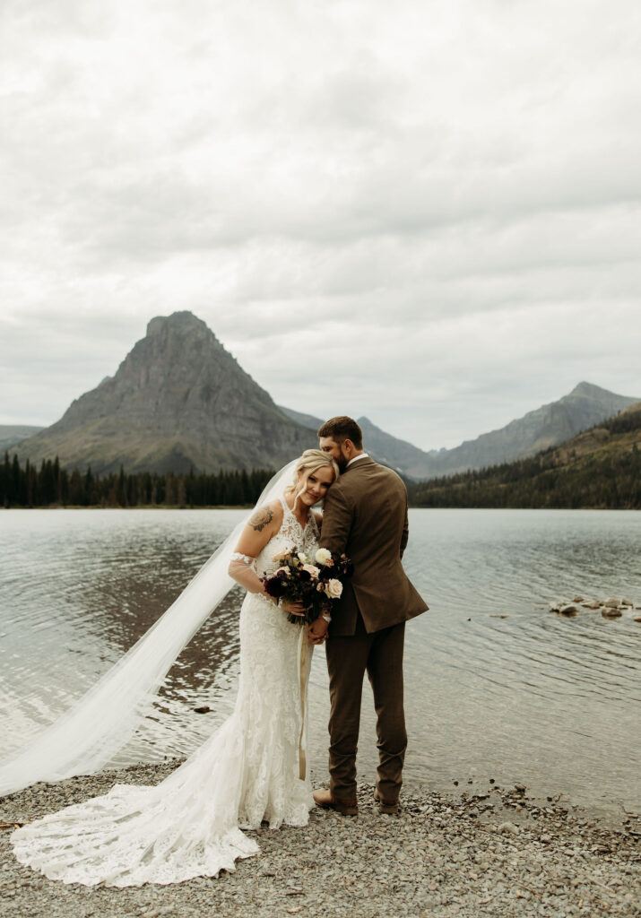 A couple embracing the wild landscapes of Glacier National Park for their elopement photos.
