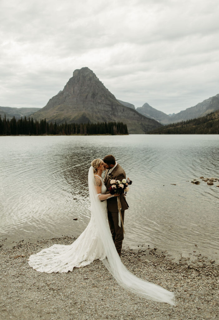 A couple embracing the wild landscapes of Glacier National Park for their elopement photos.
