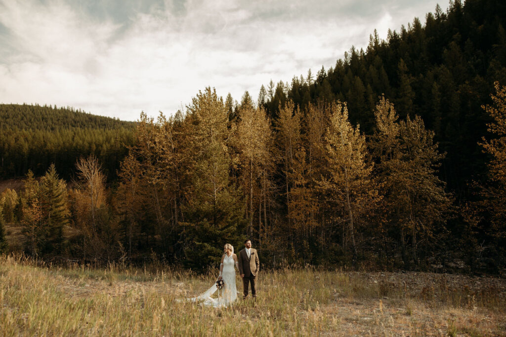 A romantic moment captured as a couple celebrates their elopement in Glacier National Park's rugged beauty.
