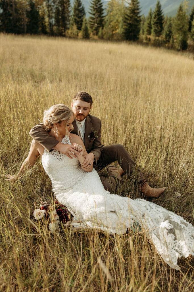 A couple standing together in Glacier National Park, surrounded by stunning mountain views during their adventure elopement.