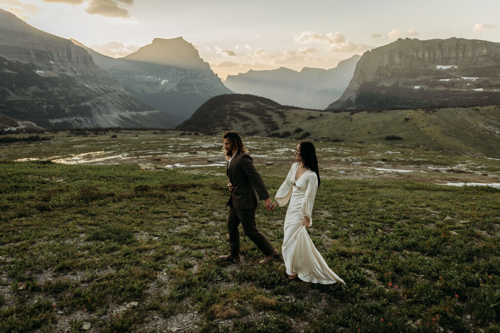 A couple standing together during their adventurous elopement photoshoot in Glacier National Park, Montana, surrounded by stunning natural scenery.
