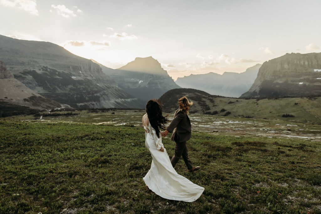 A romantic moment captured as a couple celebrates their elopement in Glacier National Park's rugged beauty.
