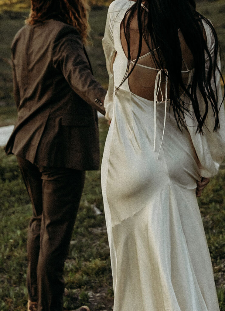 A romantic moment captured as a couple celebrates their elopement in Glacier National Park's rugged beauty.
