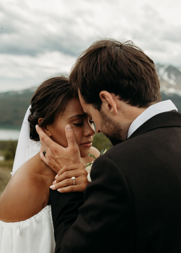 A couple standing together in Glacier National Park, capturing their adventurous destination elopement.